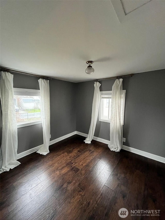 908 Washington Ave N, Long Beach, WA 98631 - spare room with baseboards and dark wood-type flooring
