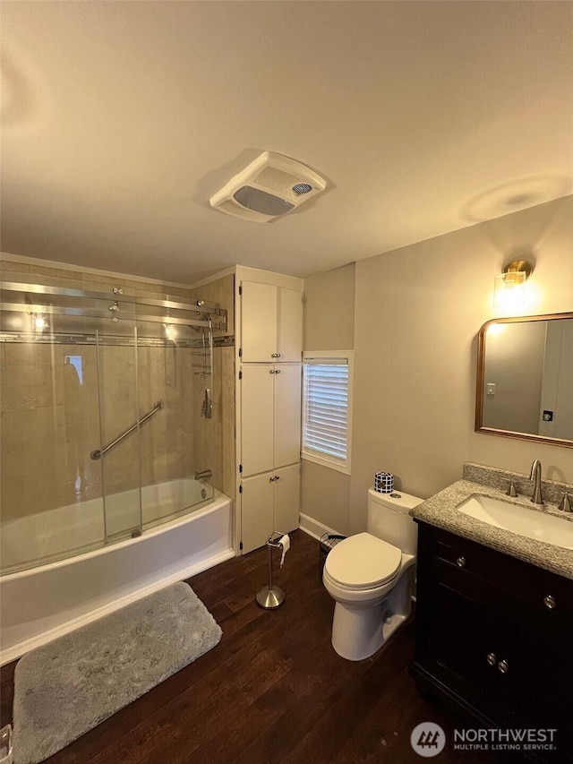 908 Washington Ave N, Long Beach, WA 98631 - full bathroom with vanity, wood finished floors, and enclosed tub / shower combo