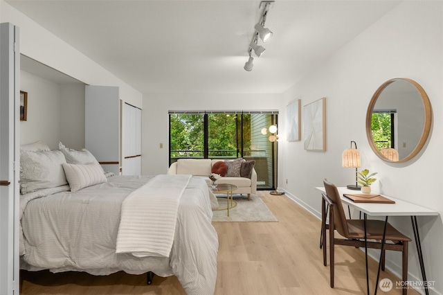 211 Summit Ave E Unit S218, Seattle, WA 98102 - bedroom with light wood finished floors, track lighting, and baseboards