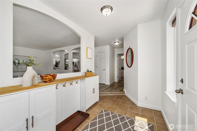 3534 SW Monroe St, Seattle, WA 98126 - corridor with light tile patterned floors, arched walkways, and baseboards