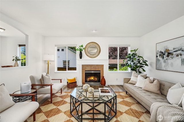 3534 SW Monroe St, Seattle, WA 98126 - living area with light wood-style flooring, arched walkways, and a fireplace
