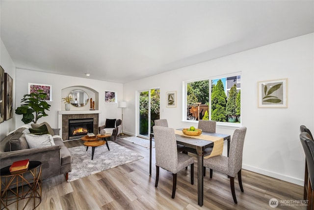 3534 SW Monroe St, Seattle, WA 98126 - dining area with a fireplace, wood finished floors, and baseboards