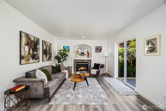 3534 SW Monroe St, Seattle, WA 98126 - living room with a fireplace, wood finished floors, and baseboards
