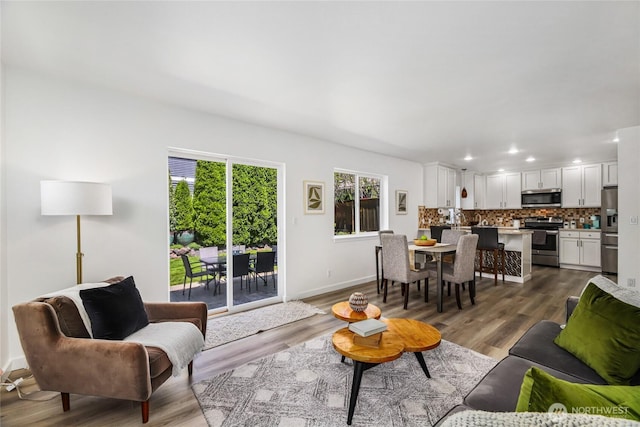 3534 SW Monroe St, Seattle, WA 98126 - living room featuring baseboards, dark wood-style flooring, and recessed lighting