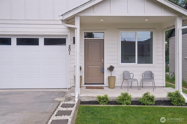 201 SE Alder St, Winlock, WA 98596 - entrance to property with board and batten siding, asphalt driveway, and an attached garage