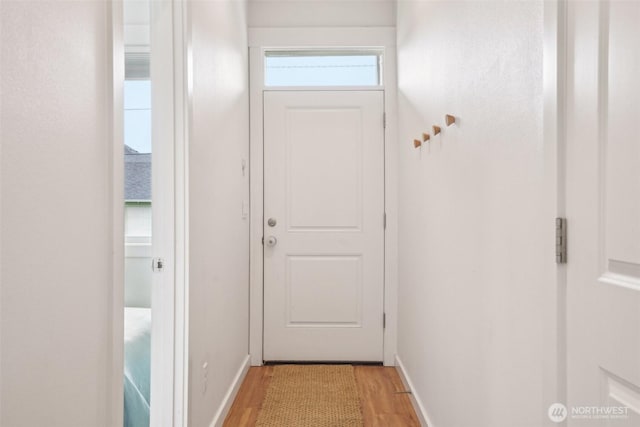 201 SE Alder St, Winlock, WA 98596 - doorway to outside featuring light wood-style flooring and baseboards