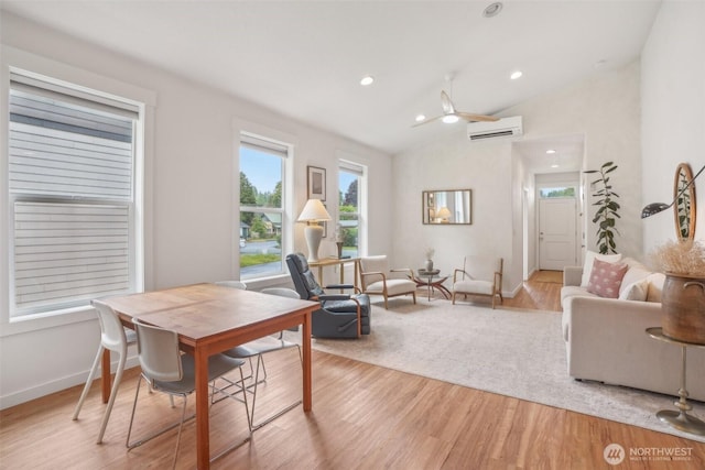 201 SE Alder St, Winlock, WA 98596 - dining room featuring an AC wall unit, vaulted ceiling, light wood-style flooring, recessed lighting, and baseboards