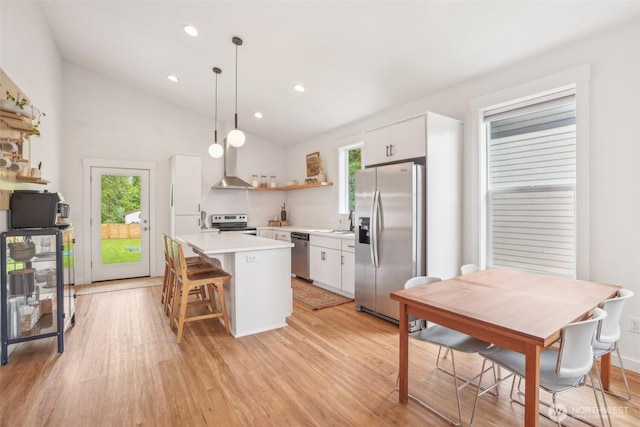 201 SE Alder St, Winlock, WA 98596 - kitchen with appliances with stainless steel finishes, open shelves, white cabinets, healthy amount of natural light, and lofted ceiling