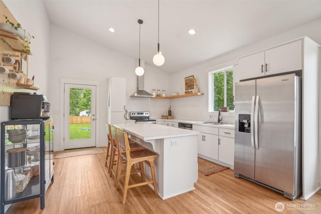 201 SE Alder St, Winlock, WA 98596 - kitchen with stainless steel appliances, open shelves, a sink, light countertops, and vaulted ceiling