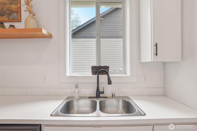 201 SE Alder St, Winlock, WA 98596 - kitchen featuring a sink, white cabinets, light countertops, and dishwasher