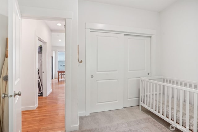 201 SE Alder St, Winlock, WA 98596 - bedroom with a closet, a crib, recessed lighting, light wood finished floors, and baseboards
