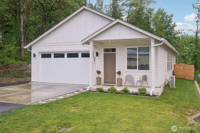 201 SE Alder St, Winlock, WA 98596 - view of front of house featuring asphalt driveway, board and batten siding, a front lawn, and an attached garage