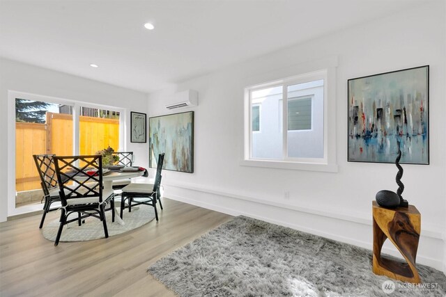 8040 19th Ave NW, Seattle, WA 98117 - dining area featuring a wall mounted AC, wood finished floors, recessed lighting, and baseboards