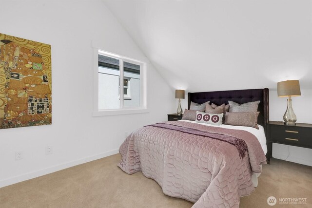 8040 19th Ave NW, Seattle, WA 98117 - carpeted bedroom featuring vaulted ceiling and baseboards