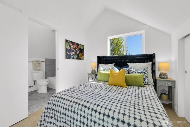 8040 19th Ave NW, Seattle, WA 98117 - bedroom with vaulted ceiling, marble finish flooring, and ensuite bathroom