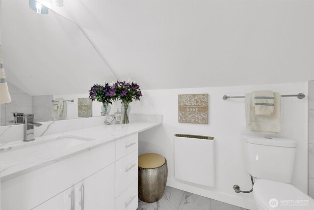 8040 19th Ave NW, Seattle, WA 98117 - bathroom featuring marble finish flooring, toilet, vanity, and vaulted ceiling