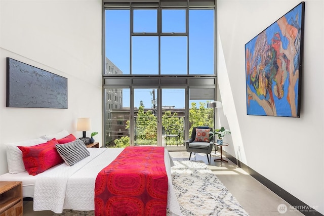 1310 E Union St Unit 401, Seattle, WA 98122 - bedroom with finished concrete flooring, a towering ceiling, and access to outside