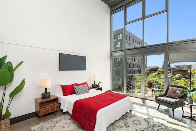 1310 E Union St Unit 401, Seattle, WA 98122 - bedroom featuring multiple windows, access to outside, and a towering ceiling