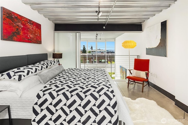 1310 E Union St Unit 401, Seattle, WA 98122 - bedroom featuring baseboards and concrete flooring