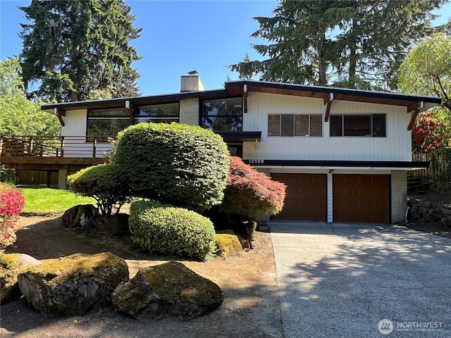 12509 SE 48th Pl, Bellevue, WA 98006 - view of front of house with a garage, a chimney, concrete driveway, and brick siding