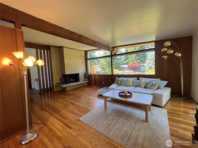 12509 SE 48th Pl, Bellevue, WA 98006 - living room featuring wood finished floors, a brick fireplace, and beam ceiling