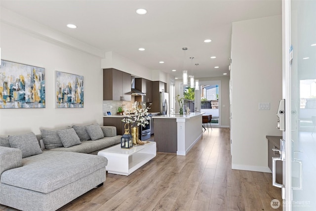 684 SW 100th St, Seattle, WA 98106 - living room with recessed lighting, light wood-type flooring, and baseboards