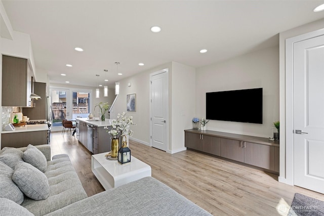 684 SW 100th St, Seattle, WA 98106 - living room with light wood-style flooring, recessed lighting, and baseboards
