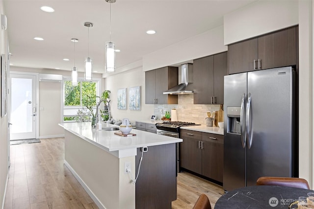 684 SW 100th St, Seattle, WA 98106 - kitchen with stainless steel appliances, wall chimney exhaust hood, a sink, dark brown cabinetry, and light countertops