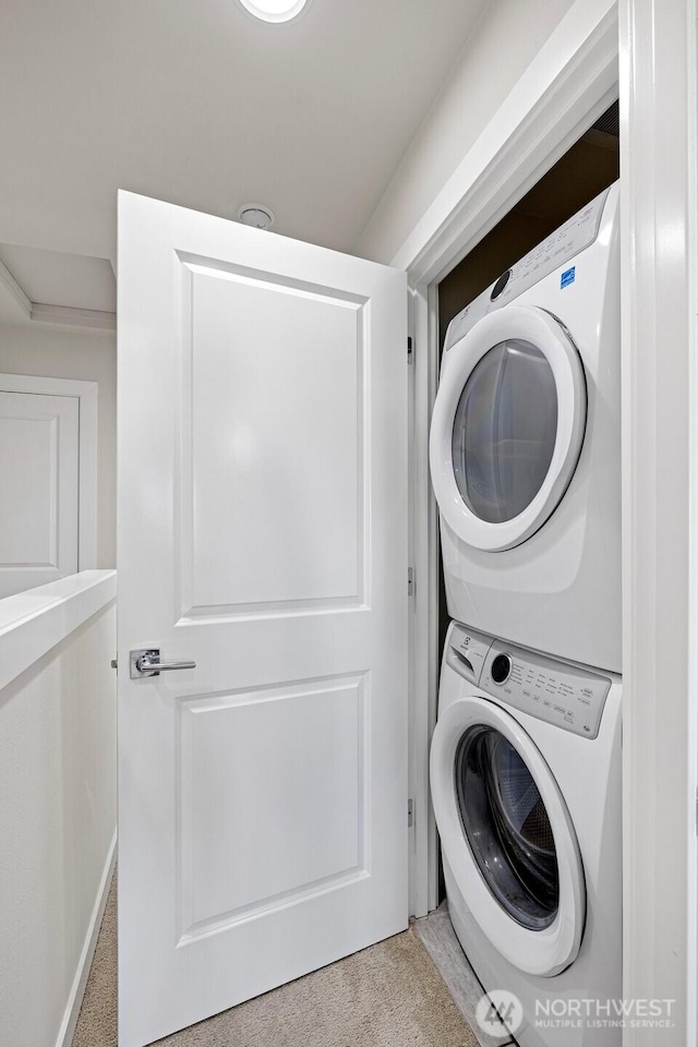 684 SW 100th St, Seattle, WA 98106 - washroom featuring stacked washer and clothes dryer and carpet flooring