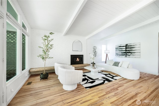 639 130th Ave NE, Bellevue, WA 98005 - living room featuring beam ceiling, wood finished floors, and a brick fireplace