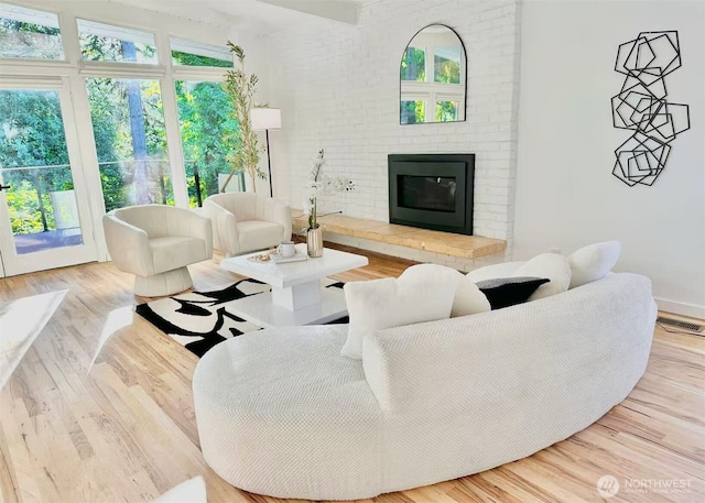 639 130th Ave NE, Bellevue, WA 98005 - living room with a fireplace, wood finished floors, and baseboards