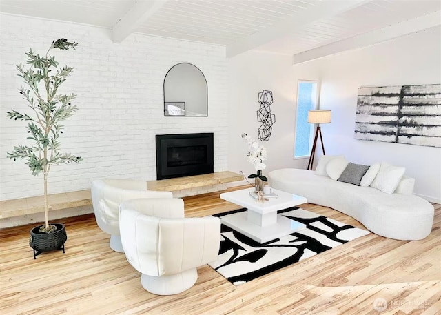 639 130th Ave NE, Bellevue, WA 98005 - living area with wood finished floors, beamed ceiling, and a brick fireplace
