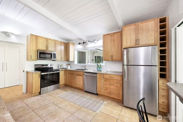 639 130th Ave NE, Bellevue, WA 98005 - kitchen featuring appliances with stainless steel finishes, light tile patterned flooring, light countertops, a sink, and wooden ceiling with exposed beams