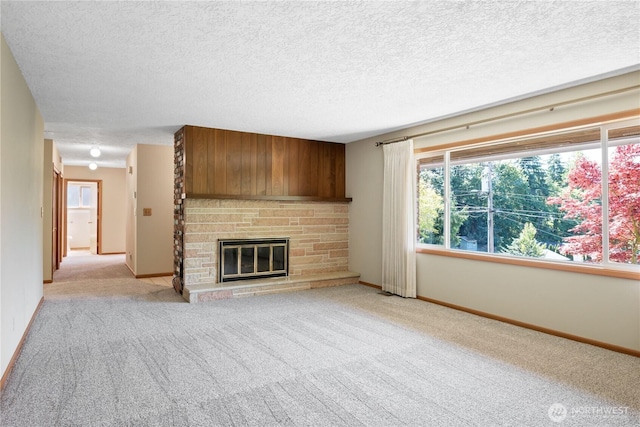 2207 Burcham St, Kelso, WA 98626 - unfurnished living room featuring a fireplace, light carpet, a textured ceiling, and baseboards