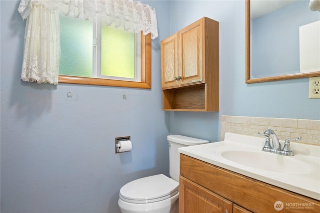 2207 Burcham St, Kelso, WA 98626 - bathroom featuring toilet, vanity, and backsplash