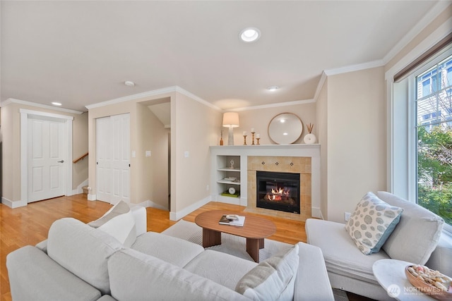 1738 NW 59th St Unit A, Seattle, WA 98107 - living area featuring light wood-type flooring, a tiled fireplace, ornamental molding, baseboards, and recessed lighting