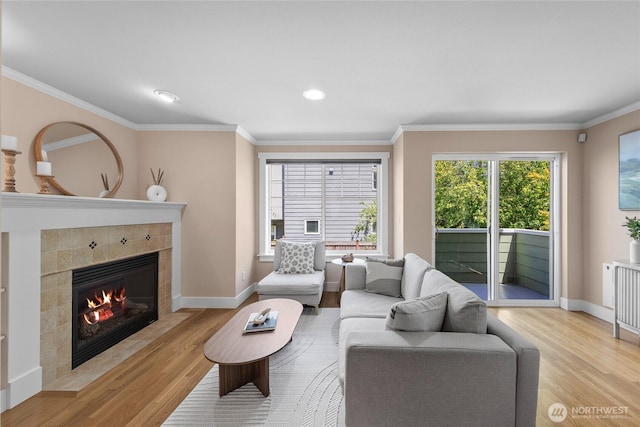 1738 NW 59th St Unit A, Seattle, WA 98107 - living area with light wood finished floors, a tile fireplace, ornamental molding, baseboards, and recessed lighting