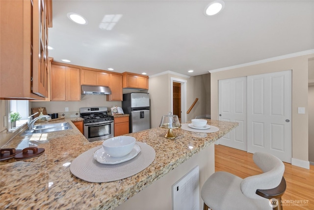 1738 NW 59th St Unit A, Seattle, WA 98107 - kitchen featuring stainless steel appliances, range hood, a sink, light wood-type flooring, and recessed lighting