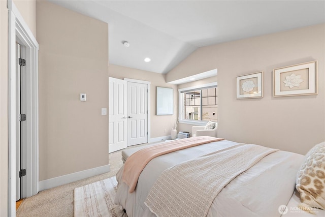 1738 NW 59th St Unit A, Seattle, WA 98107 - carpeted bedroom featuring baseboards, lofted ceiling, and a closet