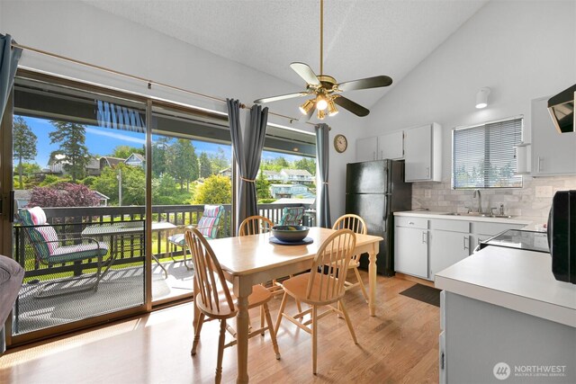 7530 Birch Bay Dr Unit 210, Blaine, WA 98230 - dining space with a ceiling fan, lofted ceiling, light wood-type flooring, and a textured ceiling
