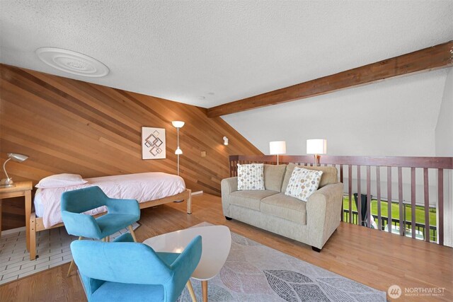 7530 Birch Bay Dr Unit 210, Blaine, WA 98230 - bedroom with wooden walls, a textured ceiling, wood finished floors, and beam ceiling