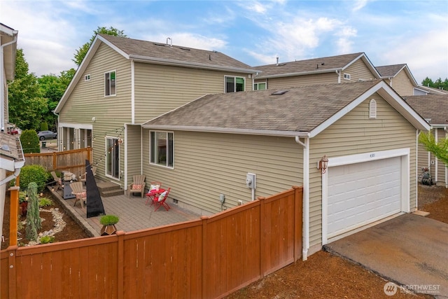 4301 Mckinley St NE, Lacey, WA 98516 - rear view of property featuring roof with shingles, asphalt driveway, a garage, a patio, and crawl space