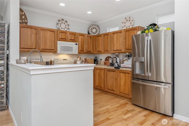 4301 Mckinley St NE, Lacey, WA 98516 - kitchen with stainless steel fridge with ice dispenser, white microwave, light wood-type flooring, ornamental molding, and range
