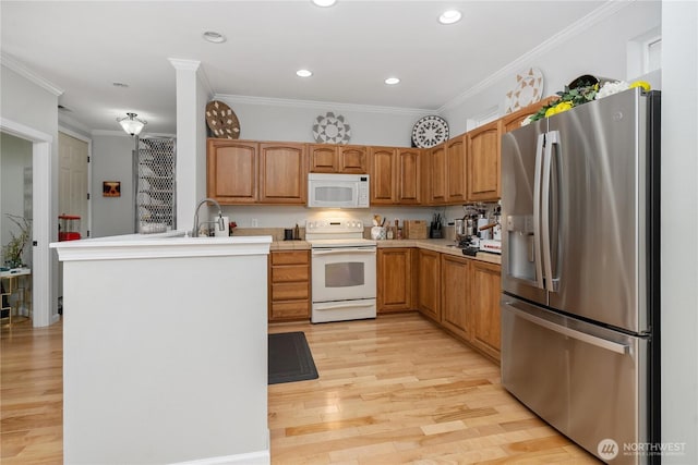 4301 Mckinley St NE, Lacey, WA 98516 - kitchen with white appliances, a peninsula, light wood-style flooring, light countertops, and crown molding