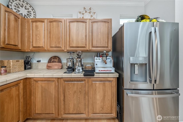 4301 Mckinley St NE, Lacey, WA 98516 - kitchen with stainless steel refrigerator with ice dispenser, crown molding, and brown cabinetry