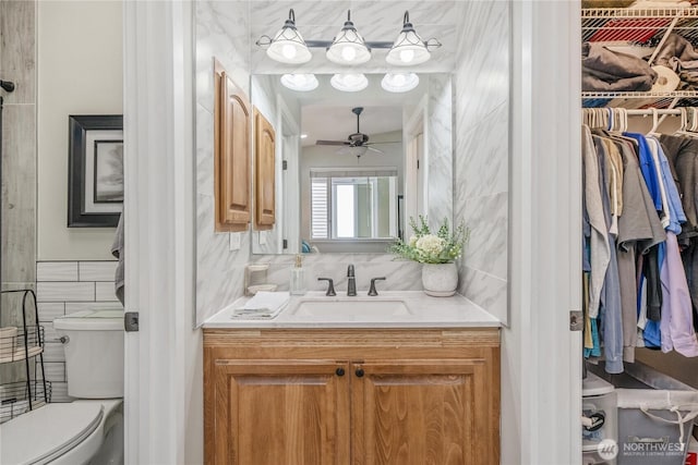 4301 Mckinley St NE, Lacey, WA 98516 - bathroom with tile walls, ceiling fan, vanity, and a spacious closet