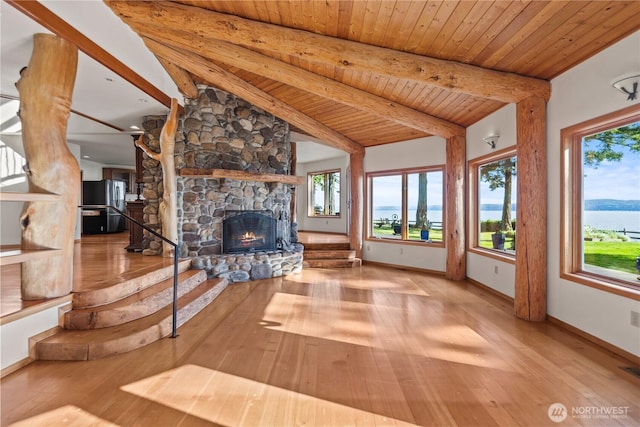 2548 S Camano Dr, Camano Island, WA 98282 - unfurnished living room featuring healthy amount of natural light, wood-type flooring, a fireplace, and wooden ceiling