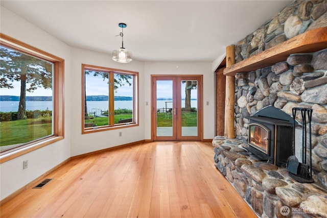 2548 S Camano Dr, Camano Island, WA 98282 - unfurnished living room featuring healthy amount of natural light, a water view, and light wood-type flooring