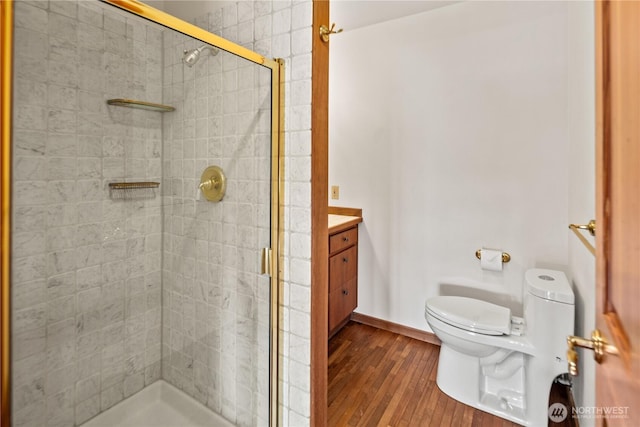 2548 S Camano Dr, Camano Island, WA 98282 - bathroom with toilet, a stall shower, wood finished floors, and vanity