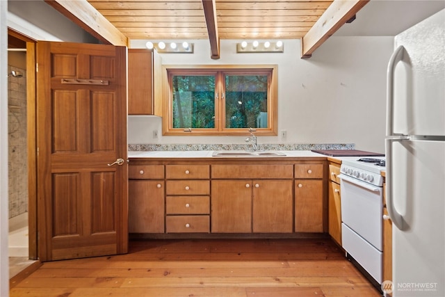 2548 S Camano Dr, Camano Island, WA 98282 - kitchen with white appliances, a sink, wooden ceiling with exposed beams, light countertops, and light wood-style floors